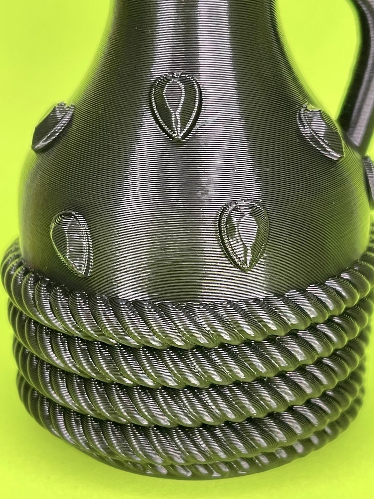 Alchemists Carafe in Black, on Green Background. Close-Up